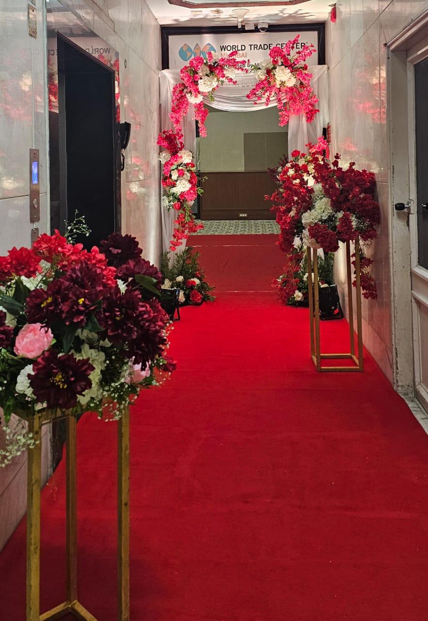 Royal red carpet entrance walkway with gold floral urns